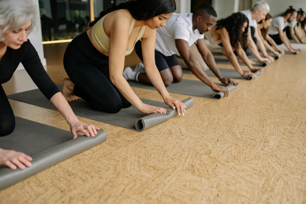 Rolled yoga mats on a studio floor — best yoga mats 2026 UK review