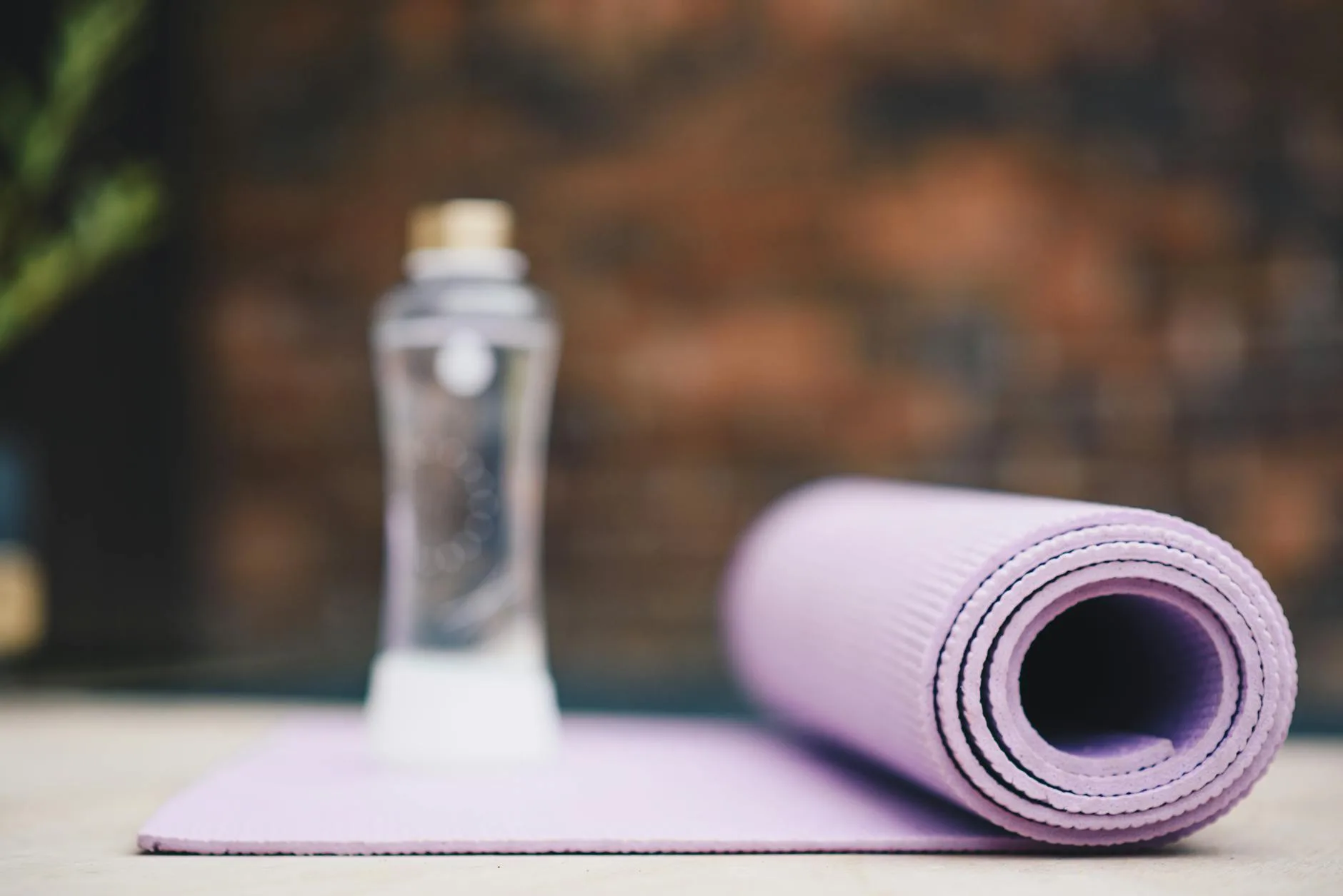 Spray bottle and cloth for cleaning and caring for a yoga mat