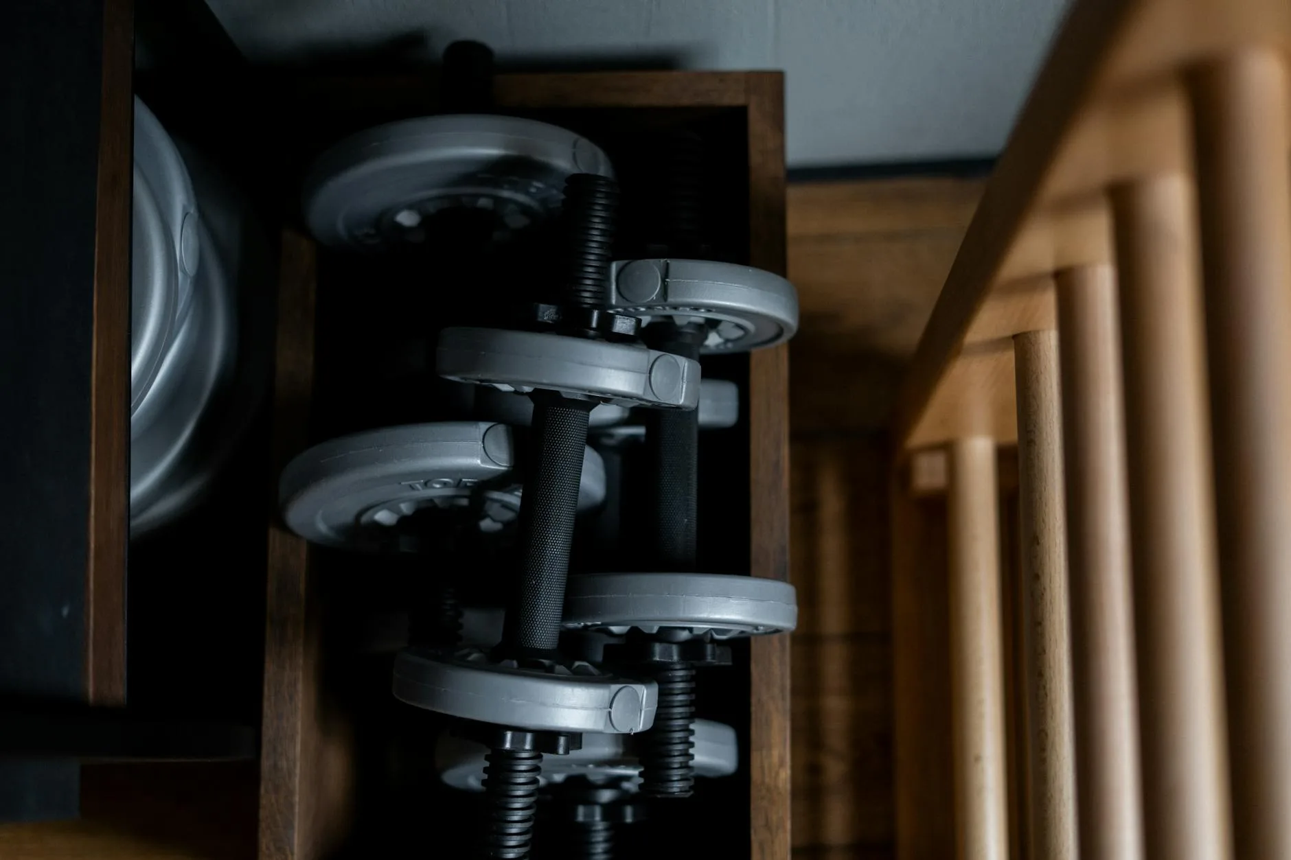 Dumbbell rack with weight plates in a home workout room
