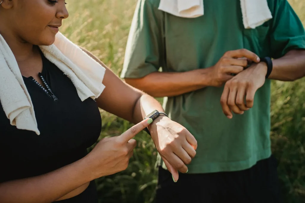 Person checking fitness tracker on wrist during gym workout