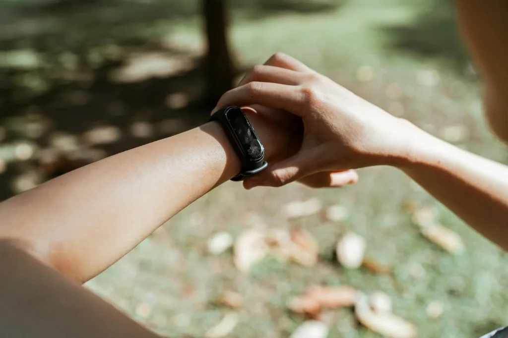 Fitness watch on a wrist showing sleep tracking data in bed