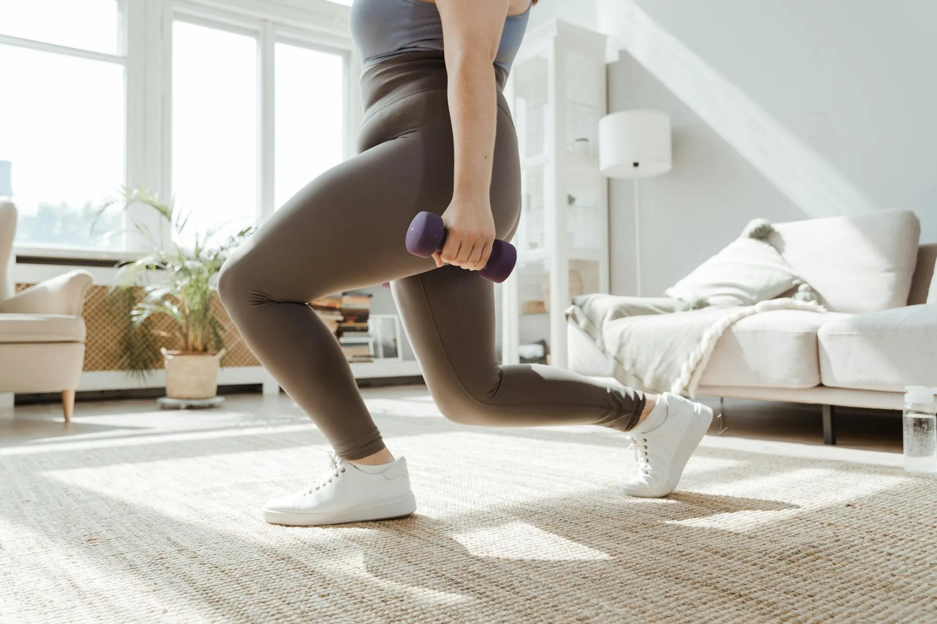 Pair of dumbbells on an exercise mat in a living room