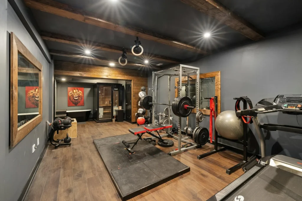 Home gym with rubber flooring, weight rack and barbell