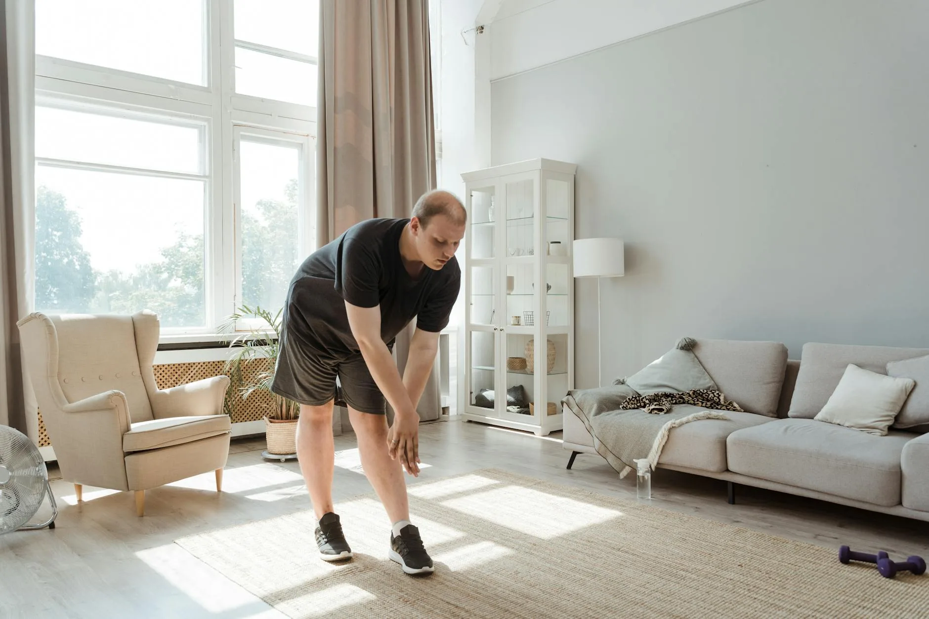 Person exercising at home with minimal equipment