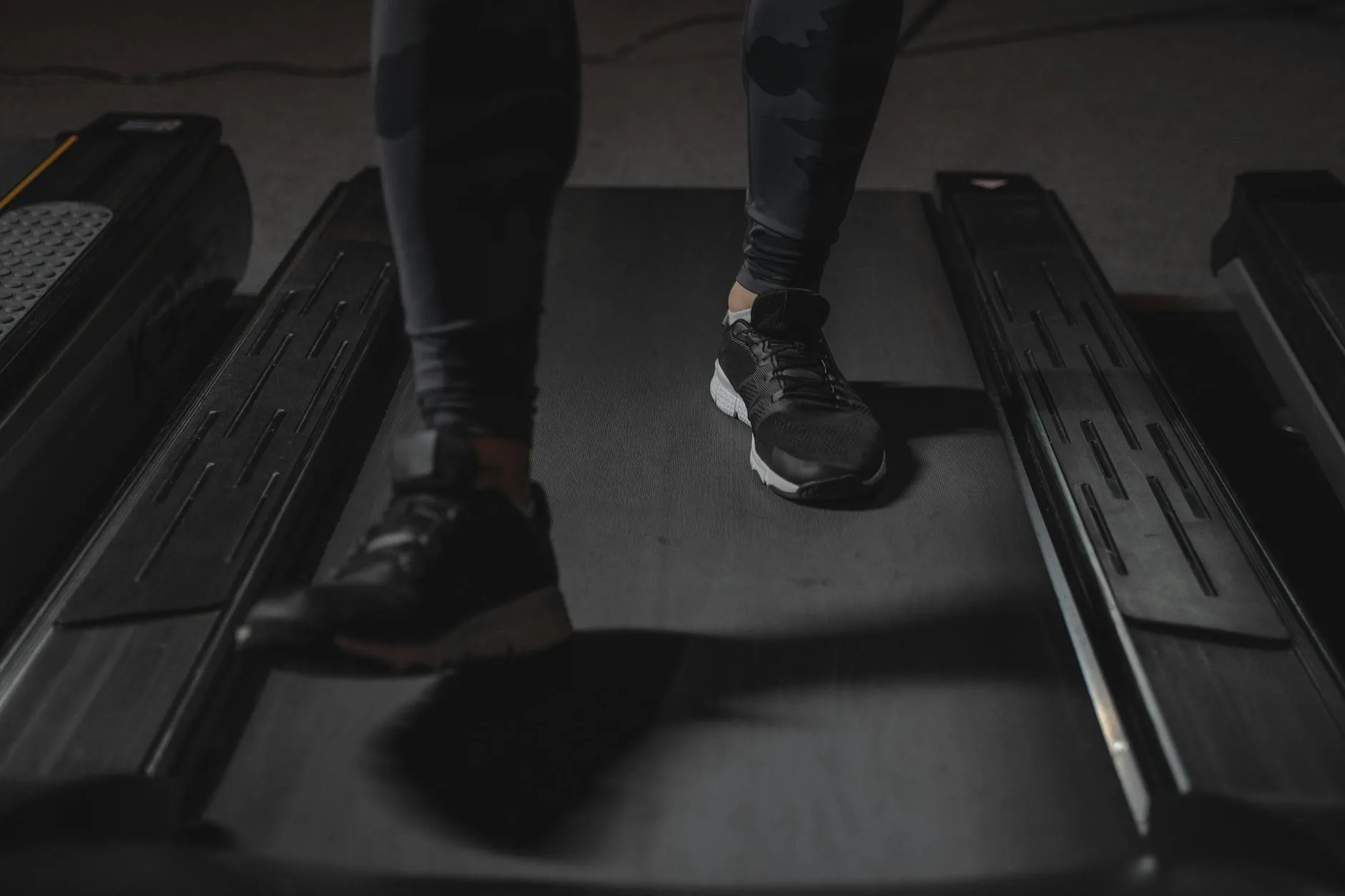 Person walking at an incline on a treadmill for fitness