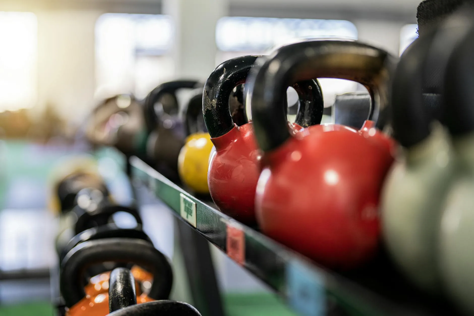 Row of kettlebells on a rack in a gym