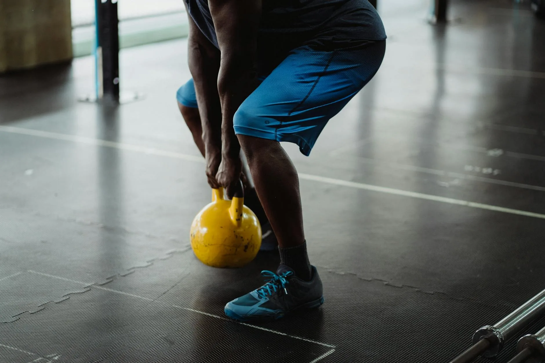 Person performing a kettlebell swing exercise