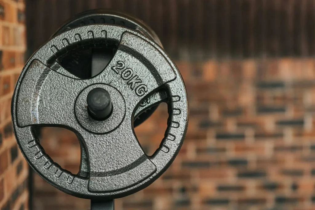 Olympic weight plates loaded on a barbell in a home gym