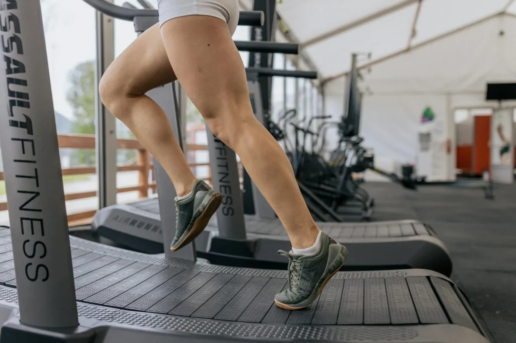 Person running on a treadmill during a gym workout