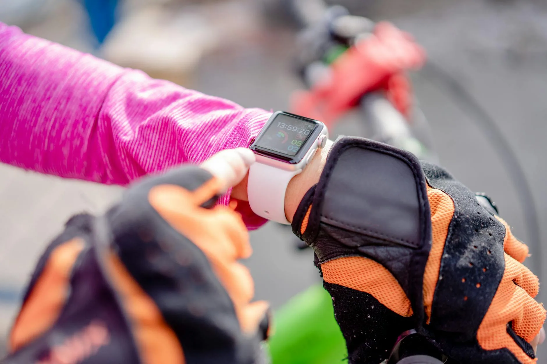 Cyclist checking GPS fitness watch during outdoor ride