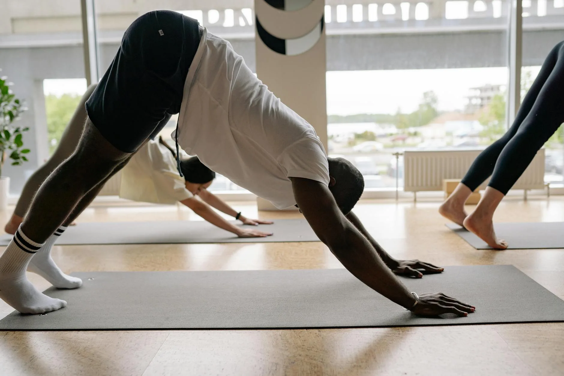 Person practising downward dog yoga pose on a mat