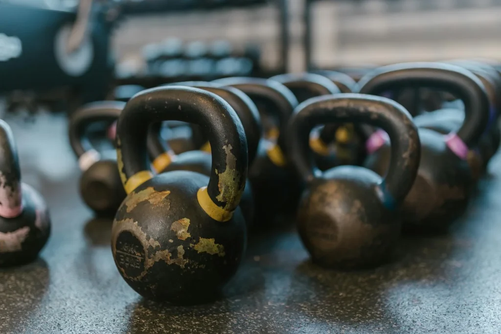 Cast iron kettlebells on a gym floor ready for training