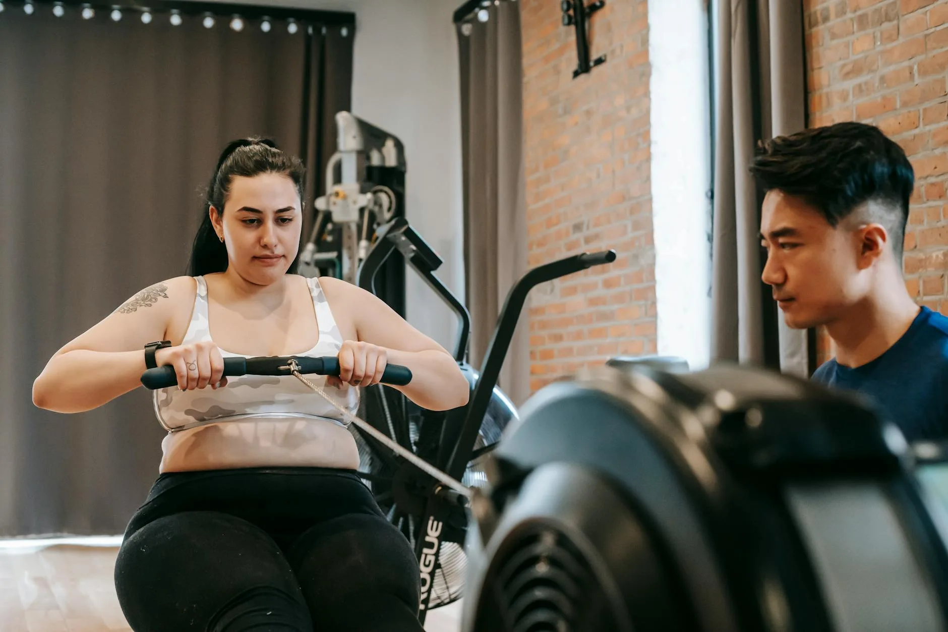Person using a rowing machine for a home HIIT workout