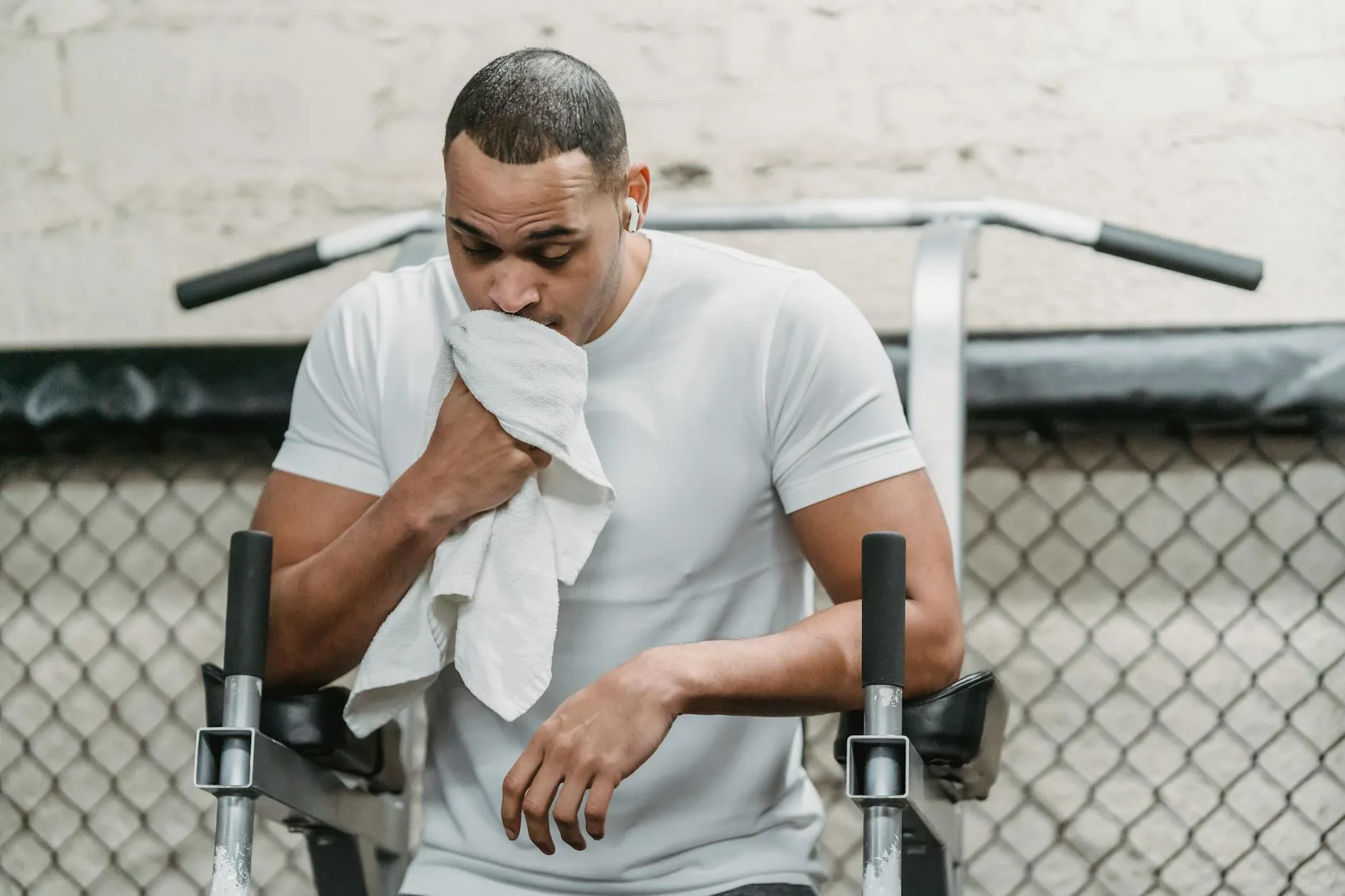 Wiping down gym equipment after a workout session