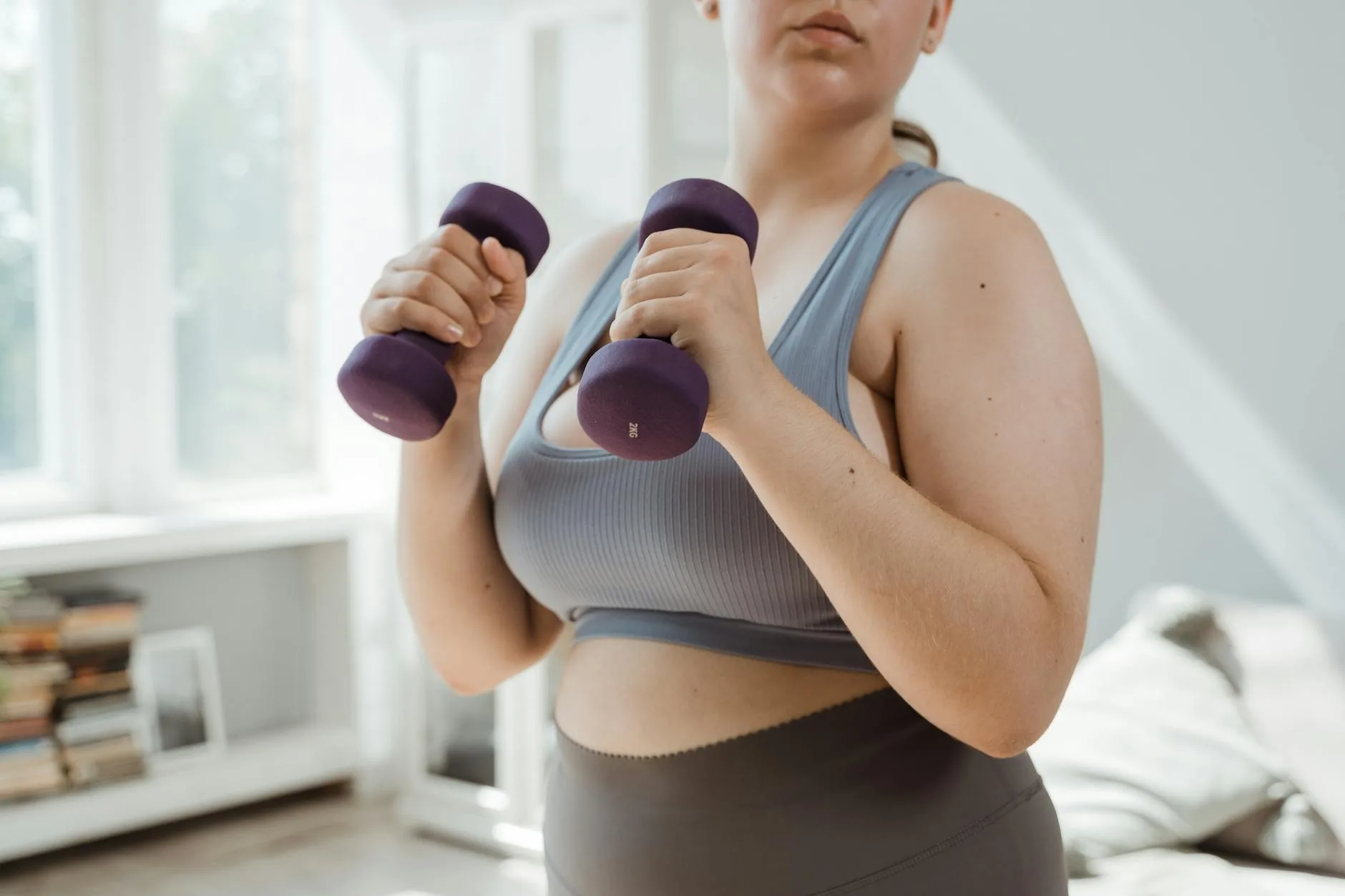 Person doing a dumbbell press exercise during a home workout