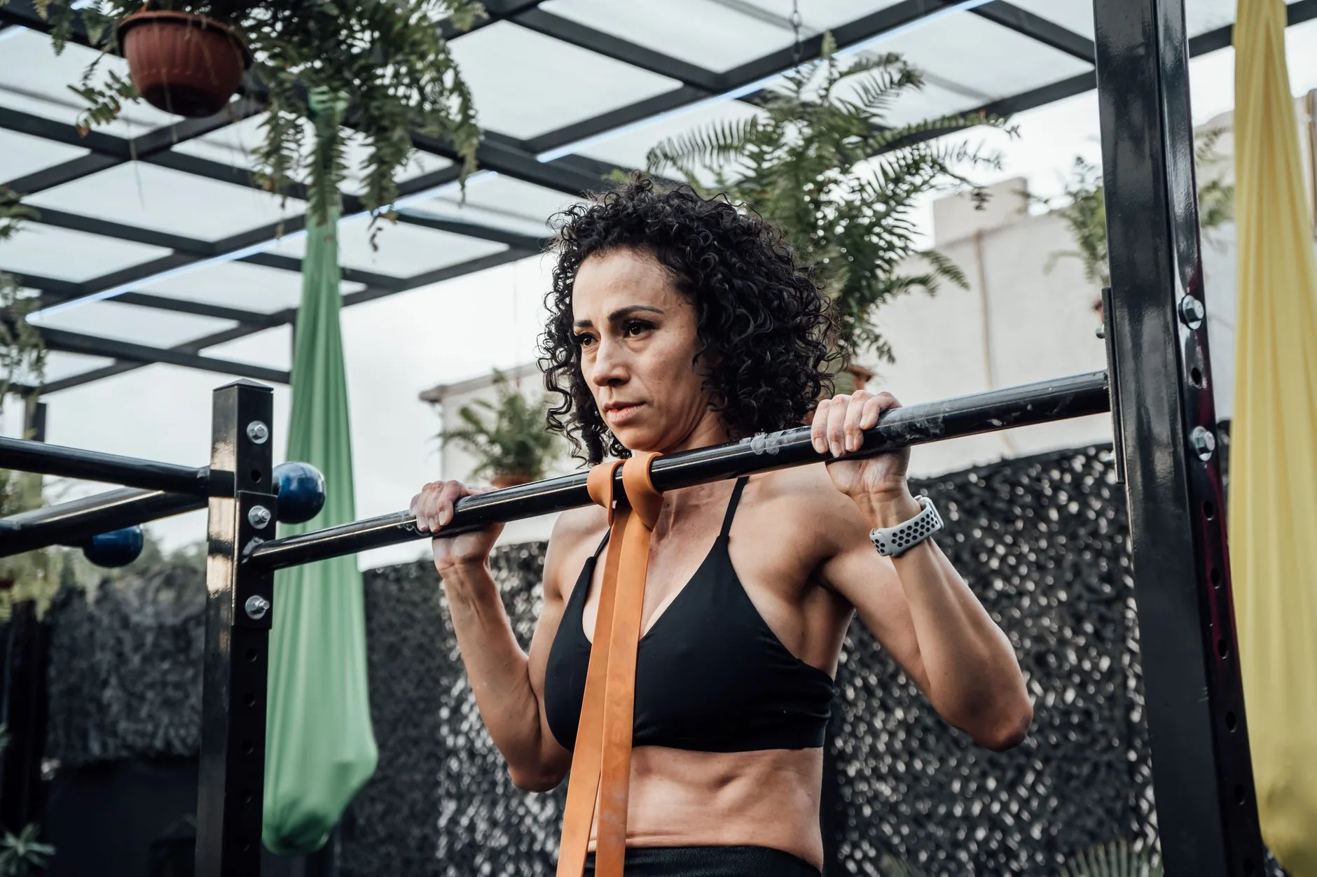Resistance band assisted pull up progression on a gym bar