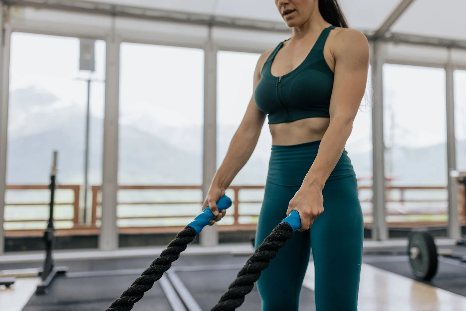Thick battle rope handles on a gym floor showing grip and diameter