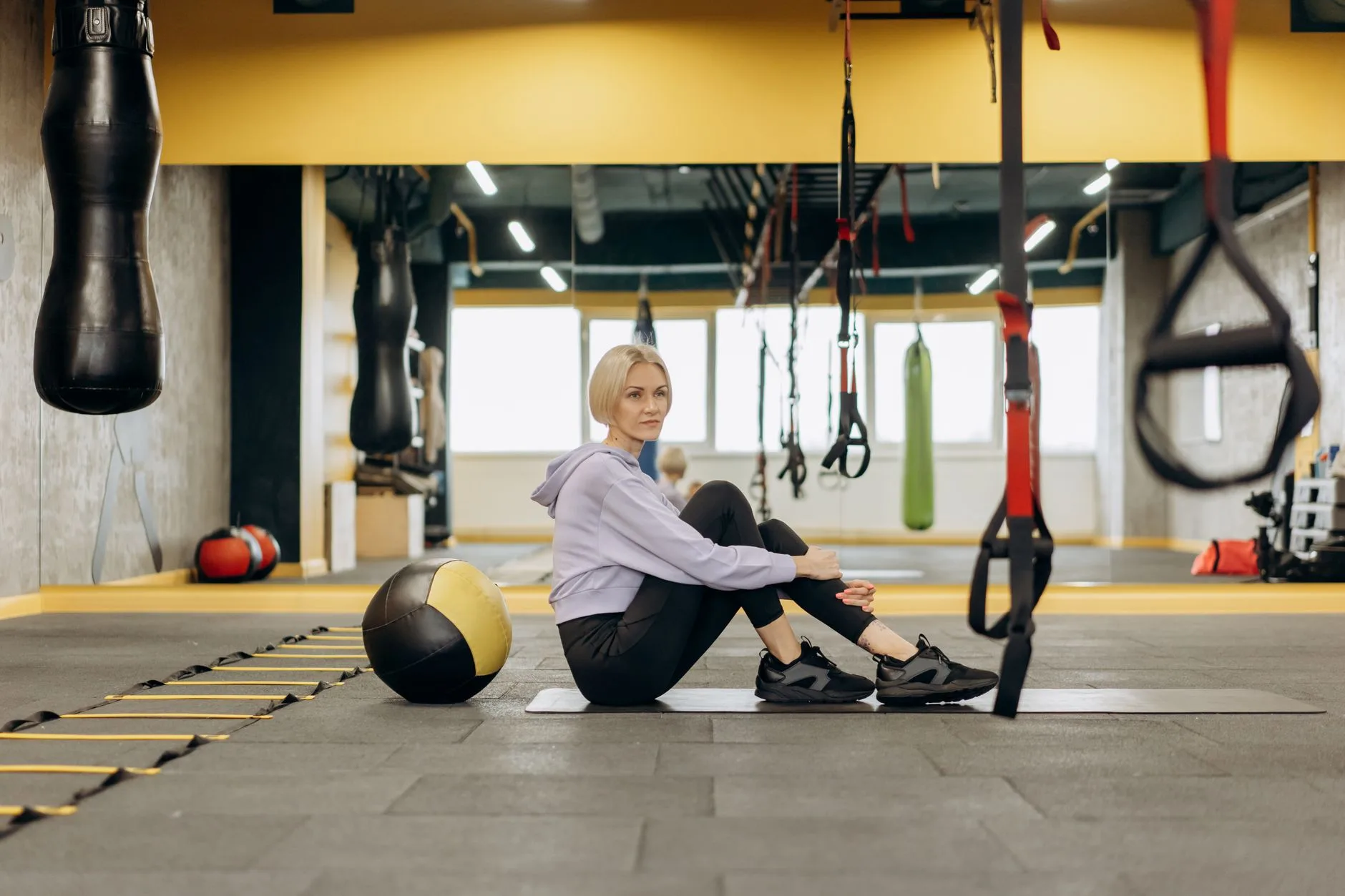 Suspension trainer handles hanging in a gym setup