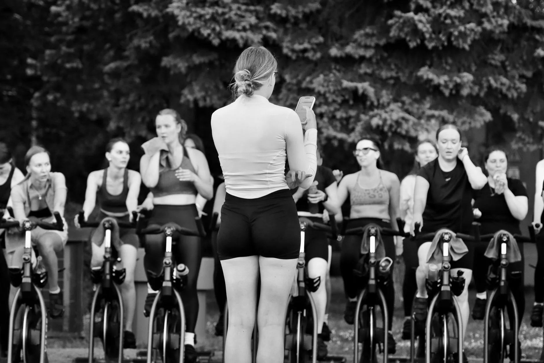 Indoor cycling class using full-size stationary exercise bikes